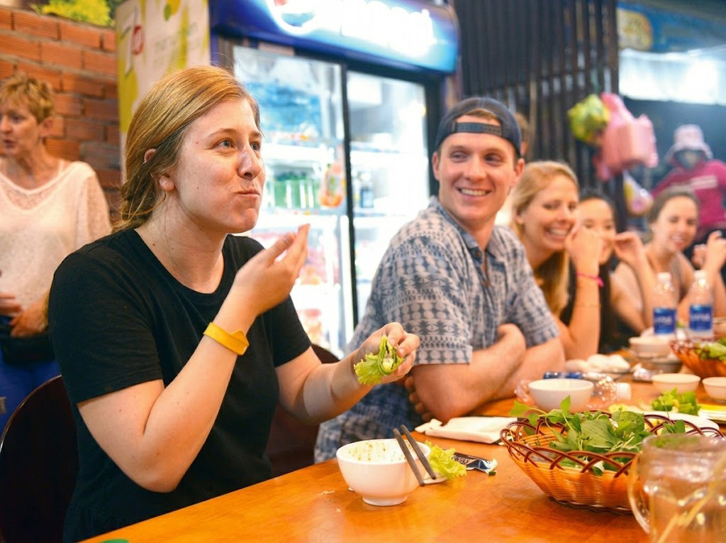 Mr. Zachary Devaney happily watches you enjoy Vietnamese Banh Xeo.